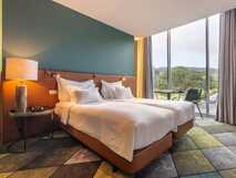 Octant Hotel Furnas, modernes und komfortables Zimmer mit großem Panoramafenster und idyllischem Ausblick auf die Natur von São Miguel.