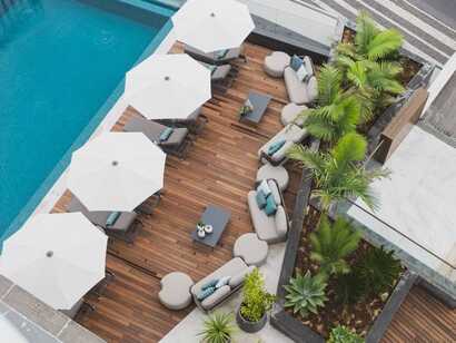 Hotel Marina Atlantico auf Sao Miguel, stilvolle Poolterrasse mit Liegen und Sonnenschirmen in entspannter Atmosphäre.
