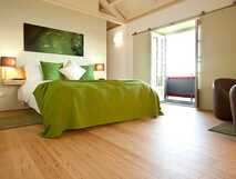 A Casa do Ouvidor auf Pico, modernes und gemütliches Schlafzimmer mit viel Licht und stilvollen grünen Akzenten und Balkon.