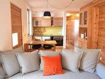 Modernes Apartment der Apartamentos Porto Pim Bay mit offener Küche, Holzdesign und gemütlichem Wohnbereich auf Faial