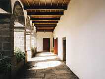 Jugendherberge Pico – ruhiger Klosterflur mit Steinbögen, Holzbalkendecke und schlichter Atmosphäre auf der Azoreninsel Pico