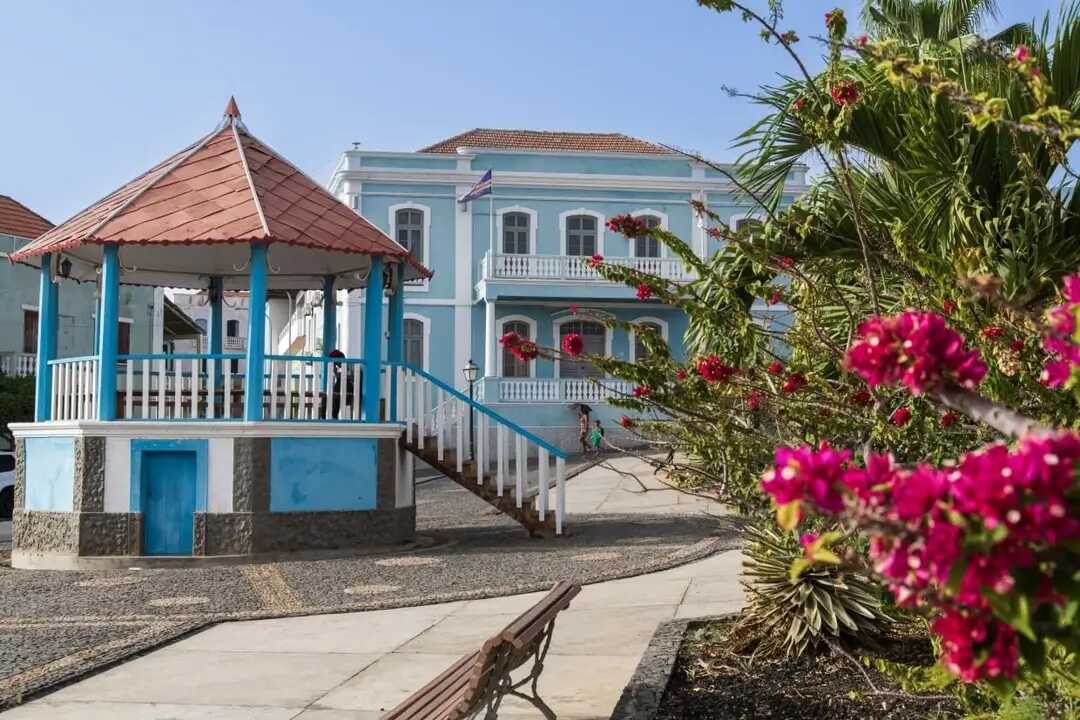 Kolonialgebäude in São Filipe auf der Kapverden-Insel Fogo mit farbenfroher Blütenpracht im Vordergrund.