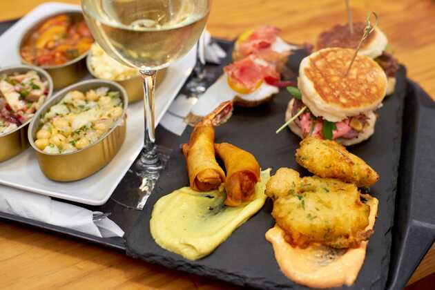 Leckeres Tablett mit Köstlichkeiten der Region Nordportugal und ein Vinho Verde, zu verkosten auf einer Nordportugal Rundreise