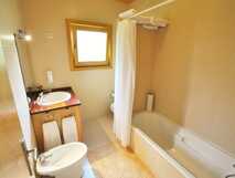 Quinta dos Curubas auf Sao Miguel, helles Badezimmer mit Badewanne und modernen Holzakzenten – komfortabel und einladend für erholsame Aufenthalte.