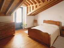 Quinta de Santana auf Sao Miguel, gemütliches Schlafzimmer mit rustikalem Charme und viel Holz in harmonischer Atmosphäre.