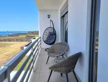 Villas do Mar auf Flores mit Balkon mit Meerblick und gemütlichen Sitzmöglichkeiten.