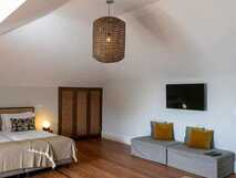 Casa Portuguesa Boutique Hotel auf Sao Miguel, gemütliches und stilvolles Zimmer mit warmem Holzboden und modernem Komfort, ideal für entspannte Aufenthalte bei picotours.